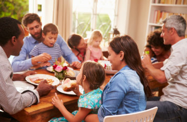 Family and friends sitting at a dining table