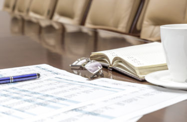 Closeup of white coffee cup on table in empty corporate conference room