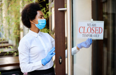 African American waitress closing a cafe due to coronavirus pandemic.